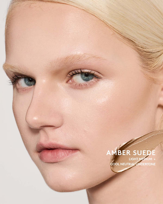 Light-medium skin toned model wearing match stix contour in shade amber suede.