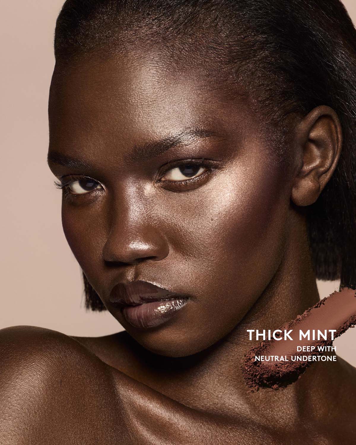 Deep skin tone model wearing sun stalk'r bronzer in shade Thick Mint.