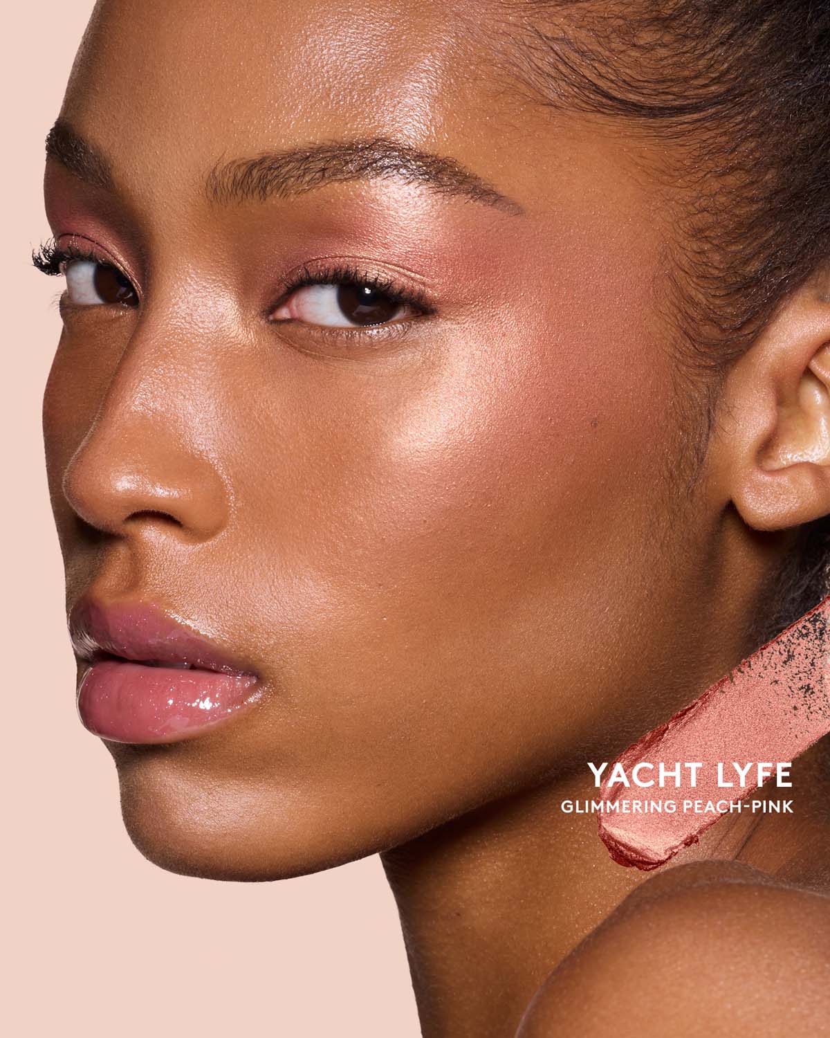 Medium-deep skin toned model wearing match stix shimmer in shade Yacht Lyfe.