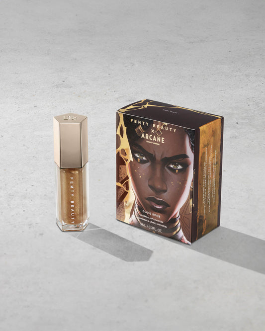 Product shot of Fenty Beauty Gloss Bomb Universal Lip Luminizer and packaging in limited edition Arcane collection shade Risky Ruling.