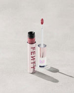 An open Fenty Icon Velvet lipstick tube on a light background.