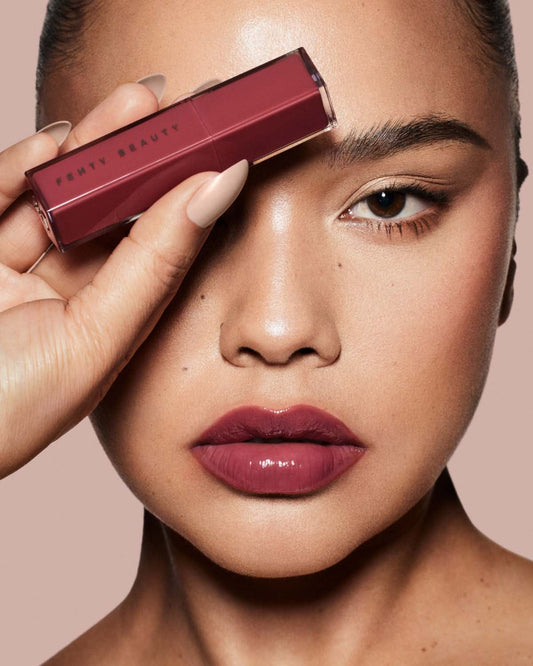 Model in Pro Filt'r shade 498 wearing Gloss Bomb Stix Lip Gloss Stick in shade Riri.