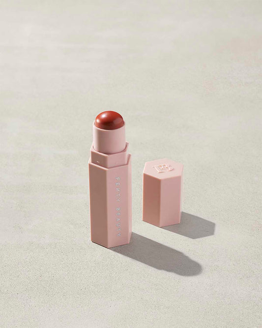 Match Stix Corrector Skinstick shown in shade Pumpkin with open packaging on a concrete background.