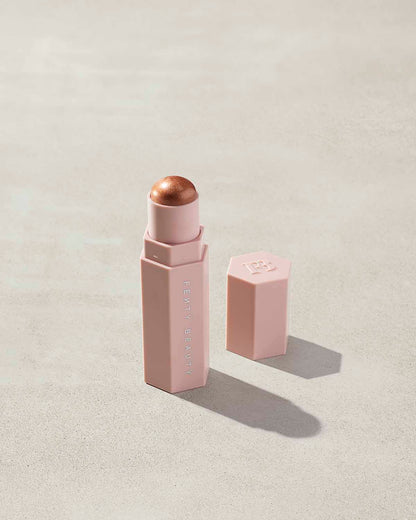 Match Stix Shimmer Skinstick shown in shade Truffle Spark on a concrete background.