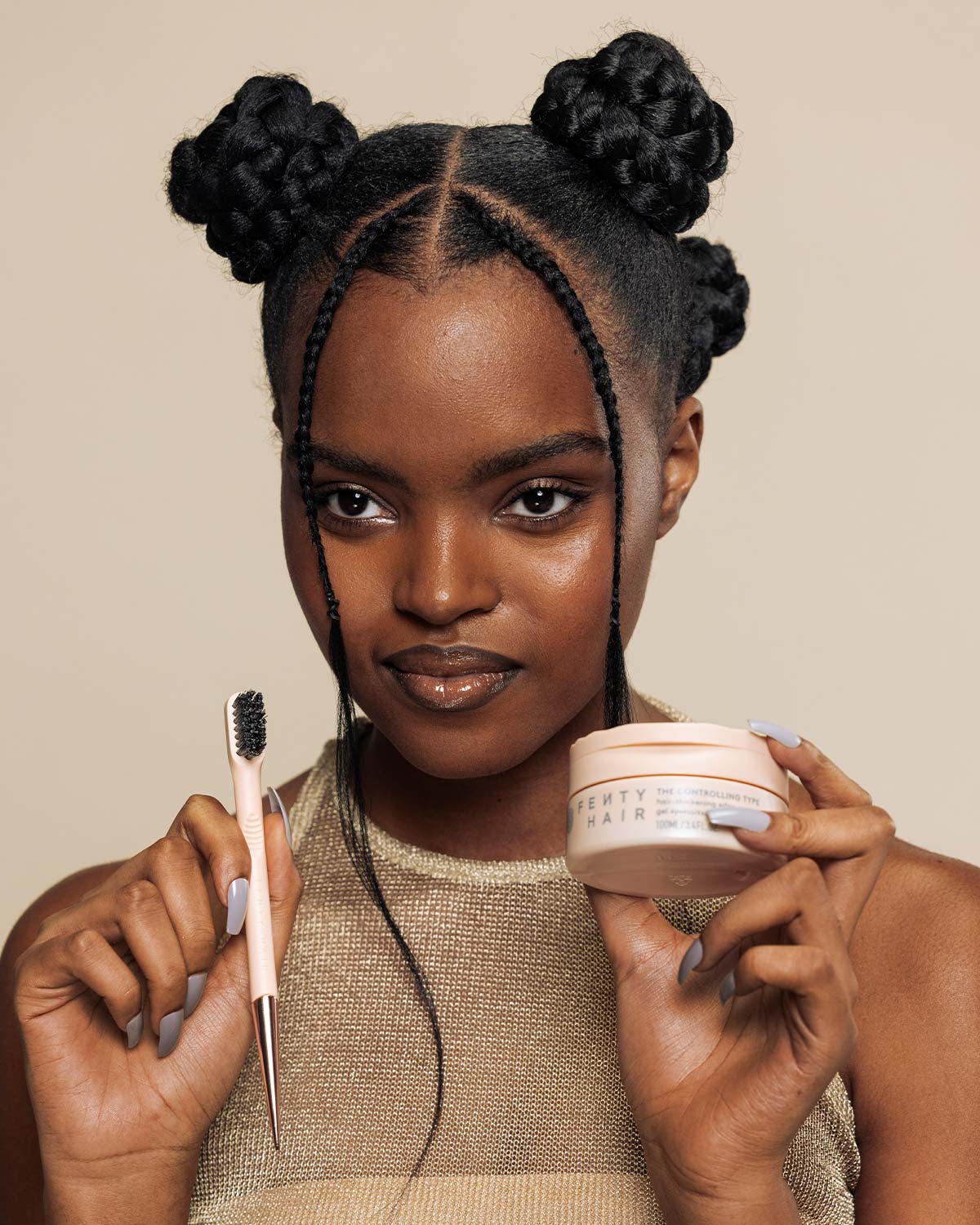 model with braided buns holding up edge control tool and controlling type