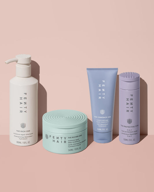 Fenty Hair shampoo next to deep conditioner, hair damage repair treatment, and 5-in-1 heat protectant hair styler.